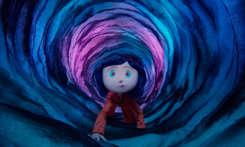 Coraline travels through a portal between worlds