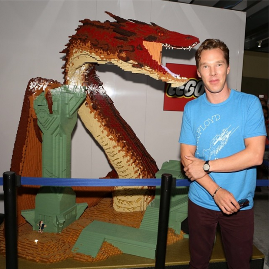 THE HOBBIT: THE BATTLE OF THE FIVE ARMIES star Benedict Cumberbatch poses alongside the LEGO Dragon Smaug in the Warner Bros. booth during SDCC 2014